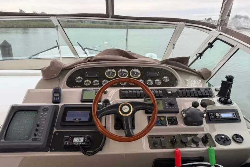 Slide: The Image of Cockpit of 2001 Cruisers Yachts 4450 Express Motoryacht with steering wheel and navigation instruments. - 8