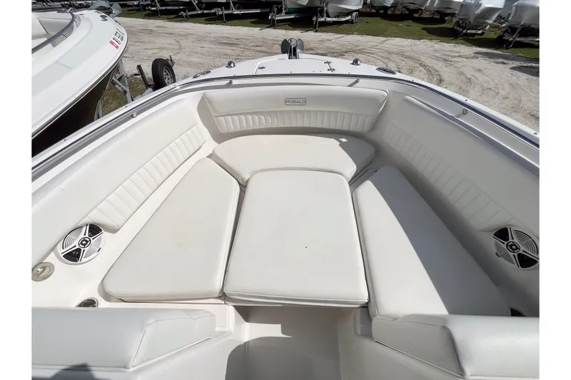 Slide: The Image of 2014 Robalo R247 Dual Console boat with spacious white seating area. - 10
