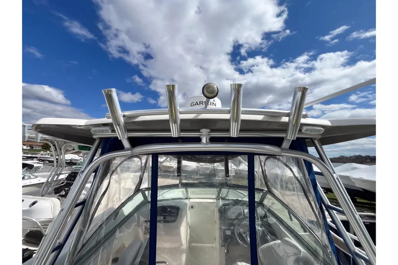 Slide: The Image of 2014 Robalo R247 Dual Console boat with Garmin equipment under a blue sky. - 12