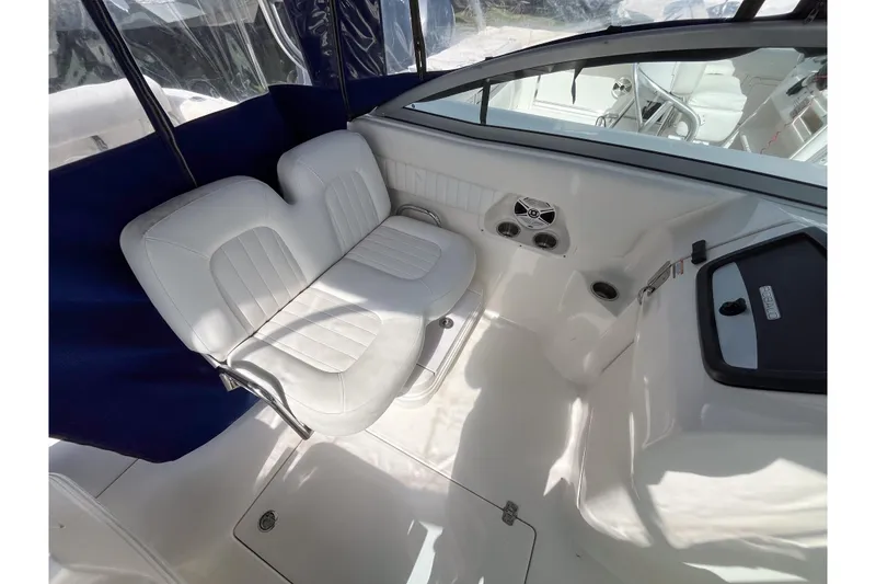 Slide: The Image of 2014 Robalo R247 Dual Console interior with white seating and blue accents. - 13