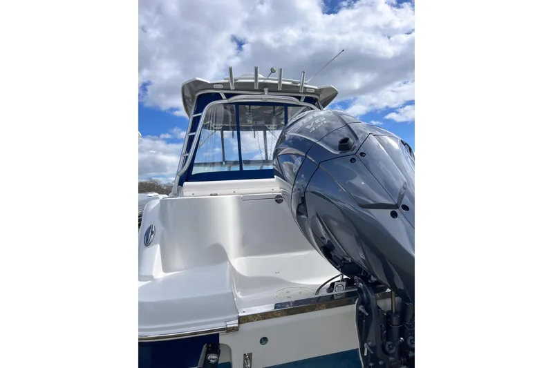 Slide: The Image of 2014 Robalo R247 Dual Console boat with powerful outboard motor under blue sky. - 16