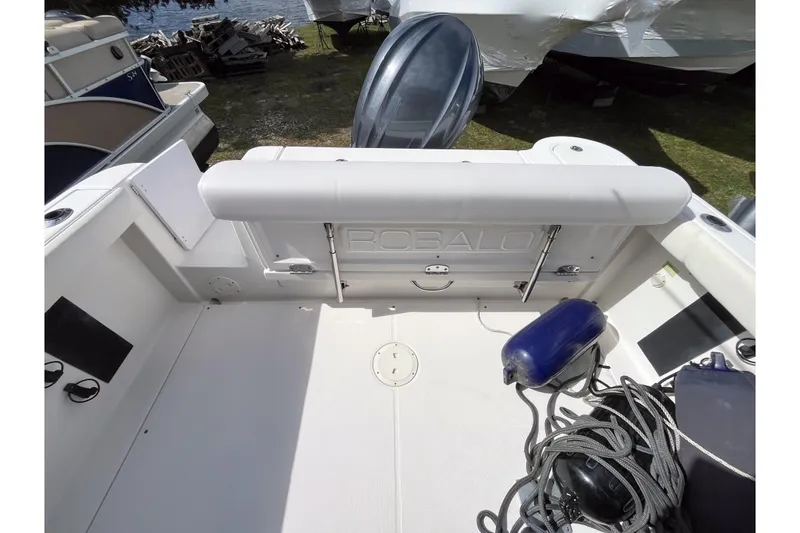 Slide: The Image of 2014 Robalo R247 Dual Console boat interior with seating and marine equipment. - 2