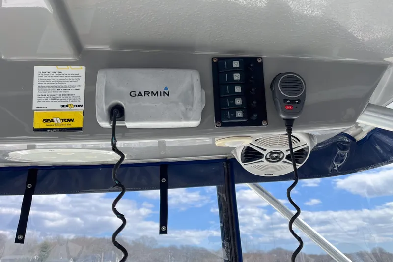 Slide: The Image of 2014 Robalo R247 Dual Console dashboard with Garmin device and Sea Tow information. - 7