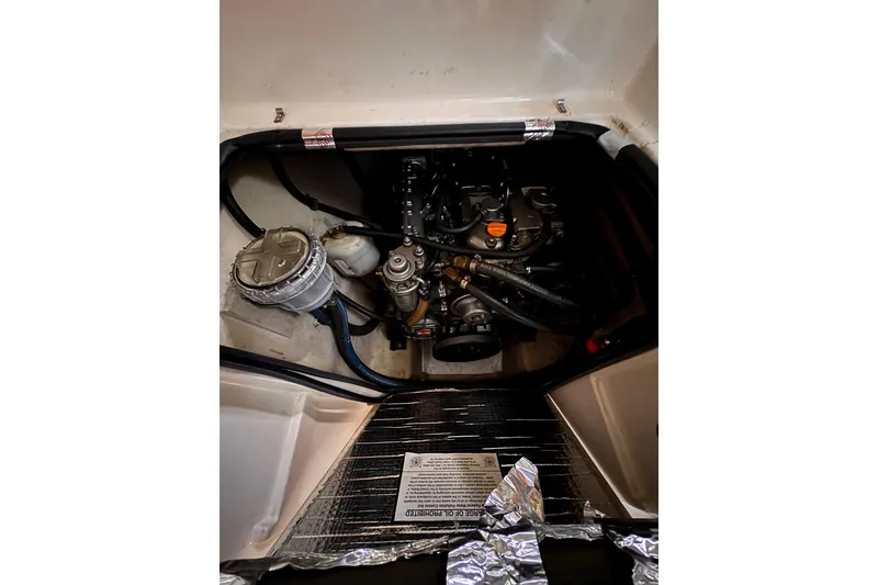 Slide: The Image of Engine compartment of a 2006 PDQ PowerCat boat, showcasing mechanical components. - 10