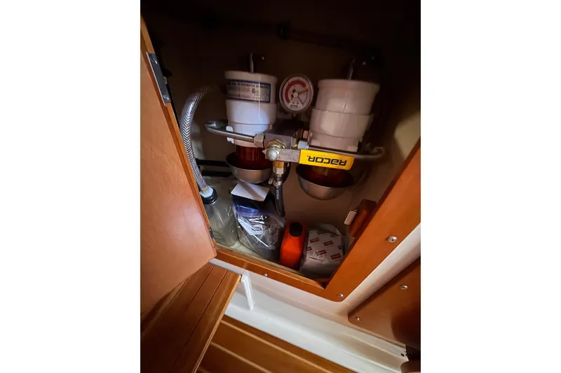 Slide: The Image of 2006 PDQ PowerCat engine compartment with Racor fuel filter system and storage. - 11