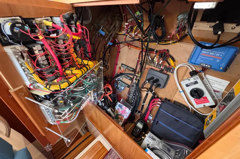 Slide: The Image of Electrical system inside a 2006 PDQ PowerCat, featuring wiring and solar charge controller. - 13