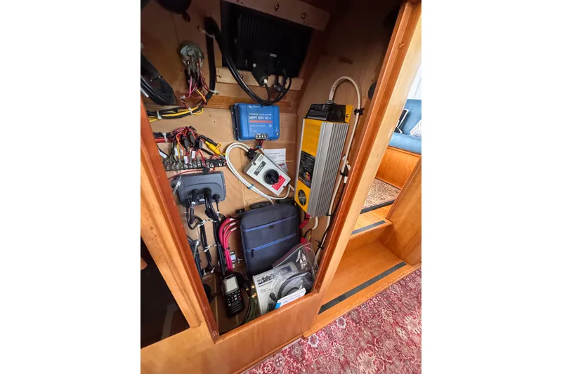 Slide: The Image of Electrical panel inside a 2006 PDQ PowerCat boat, showcasing wiring and equipment. - 14