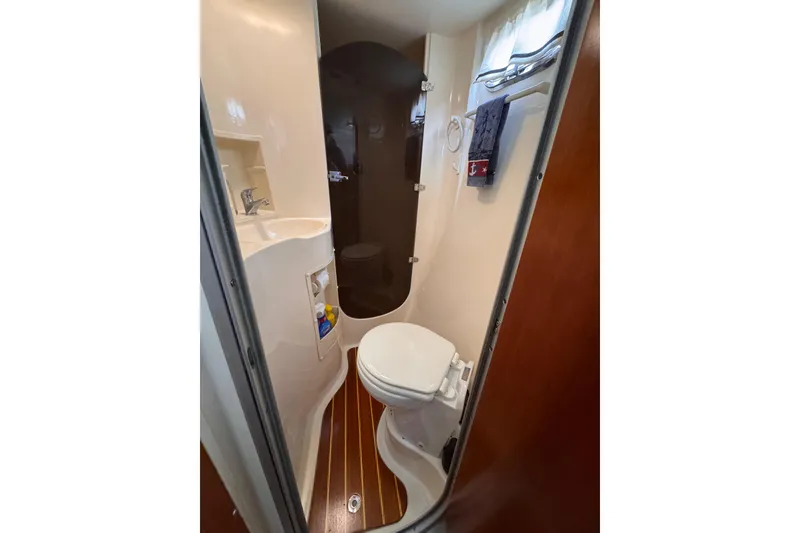 Slide: The Image of Compact bathroom in 2006 PDQ PowerCat boat with toilet, sink, and shower. - 17