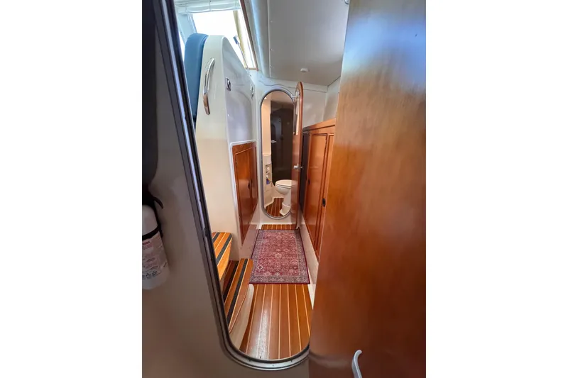 Slide: The Image of Interior of 2006 PDQ PowerCat showing wooden cabinetry and a compact bathroom. - 21