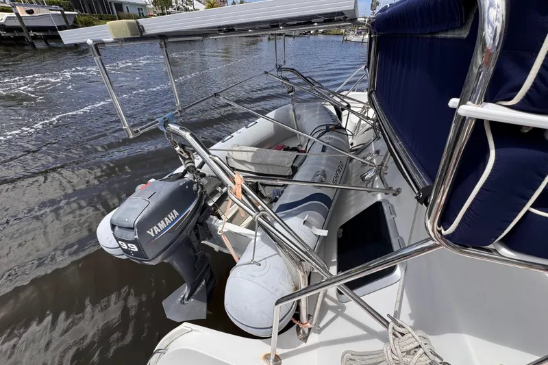 Slide: The Image of 2006 PDQ PowerCat with Yamaha outboard motor and inflatable dinghy on water. - 24