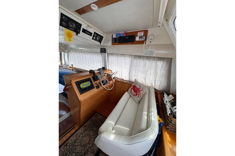Slide: The Image of Interior of 2006 PDQ PowerCat boat with helm, seating, and navigation equipment. - 3