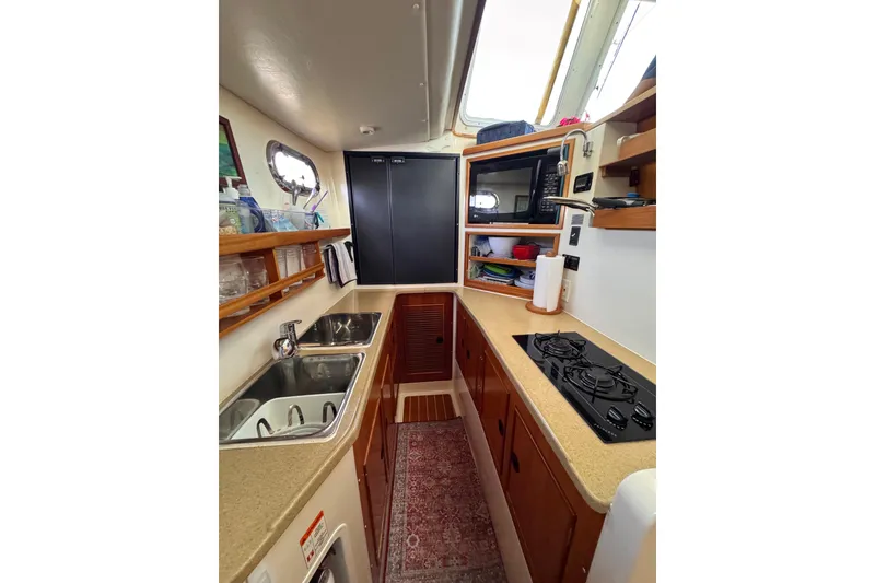 Slide: The Image of 2006 PDQ PowerCat kitchen interior with sink, stove, and storage shelves. - 7