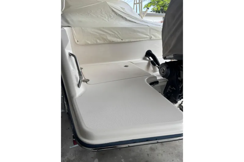 Slide: The Image of 2022 Grady-White Freedom 235 boat deck with covered engine and railing. - 12