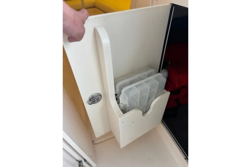 Slide: The Image of Storage compartment with tackle boxes in a 2022 Grady-White Freedom 235 boat. - 18