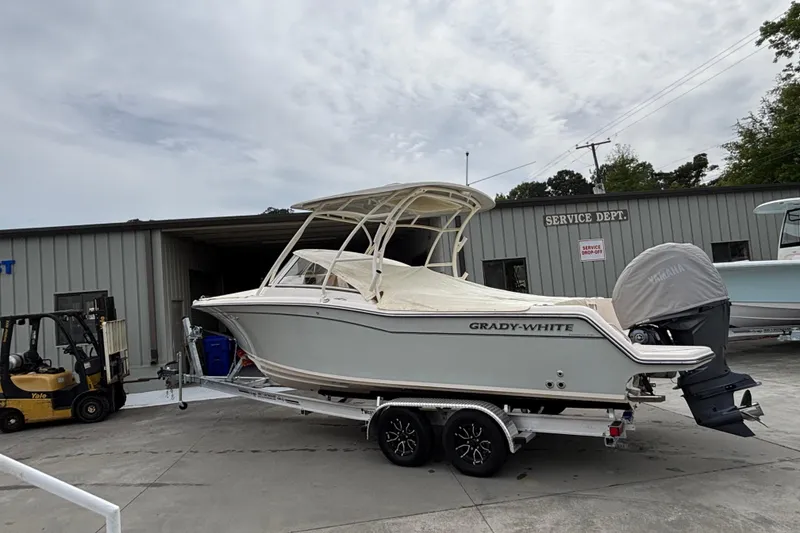 Slide: The Image of 2022 Grady-White Freedom 235 boat on trailer outside service department. - 2