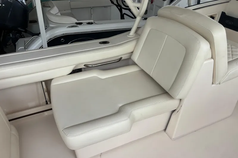 Slide: The Image of 2022 Grady-White Freedom 235 boat interior with luxurious white seating. - 20