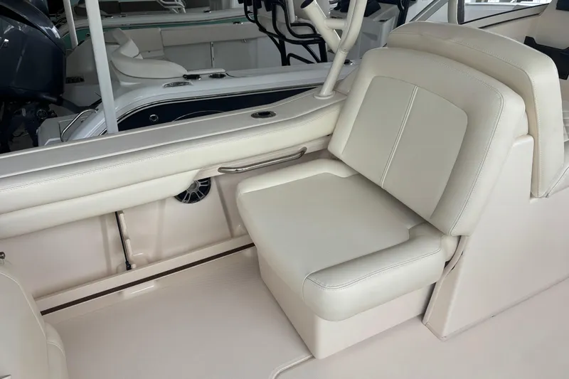 Slide: The Image of 2022 Grady-White Freedom 235 boat interior with beige seating and sleek design. - 21