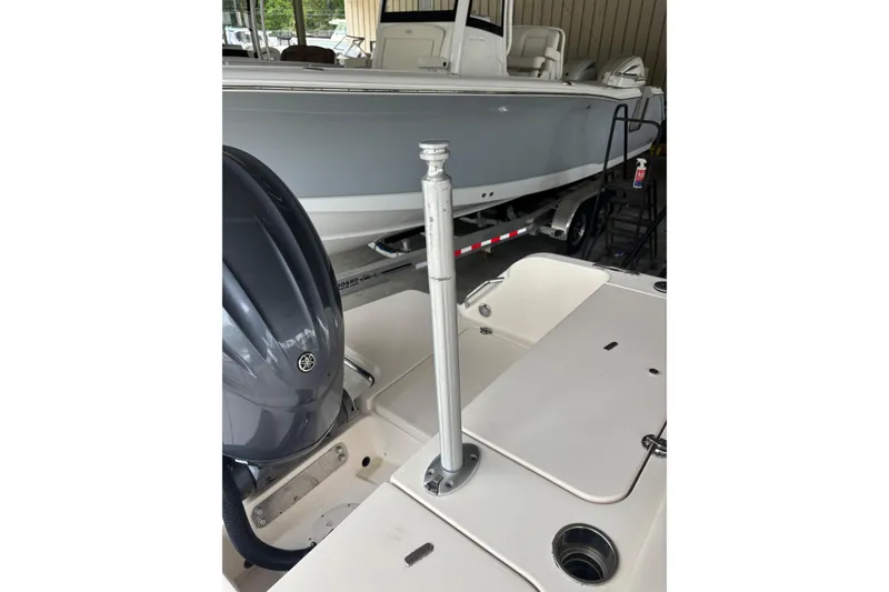 Slide: The Image of 2022 Grady-White Freedom 235 boat with Yamaha engine, docked indoors. - 24