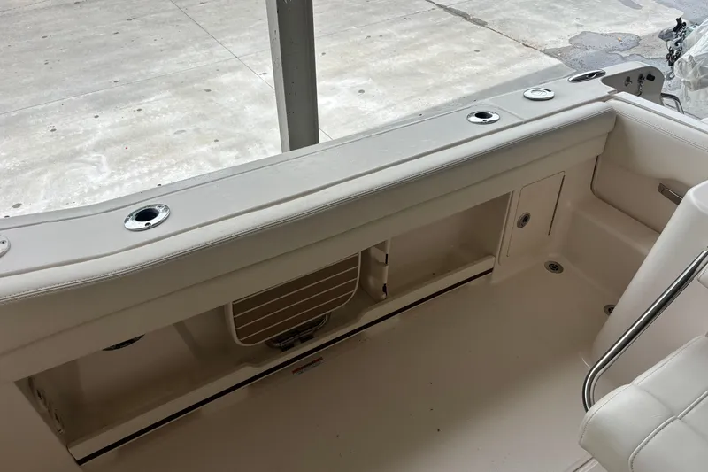 Slide: The Image of 2022 Grady-White Freedom 235 boat interior with seating and storage compartments. - 26