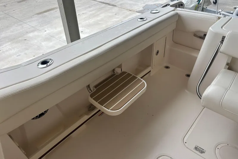 Slide: The Image of 2022 Grady-White Freedom 235 boat interior with seating and storage compartments. - 27