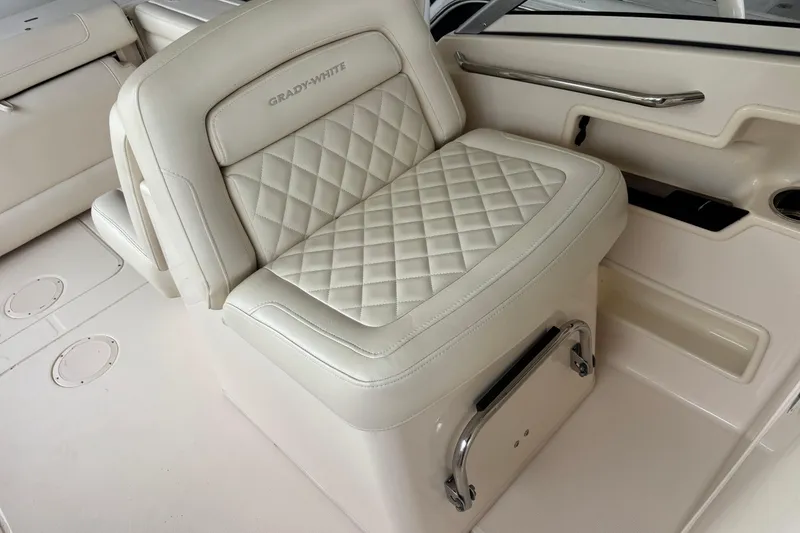 Slide: The Image of 2022 Grady-White Freedom 235 boat seat with quilted upholstery and storage compartment. - 28