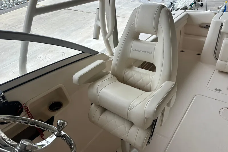 Slide: The Image of 2022 Grady-White Freedom 235 boat interior with luxurious white seating. - 29