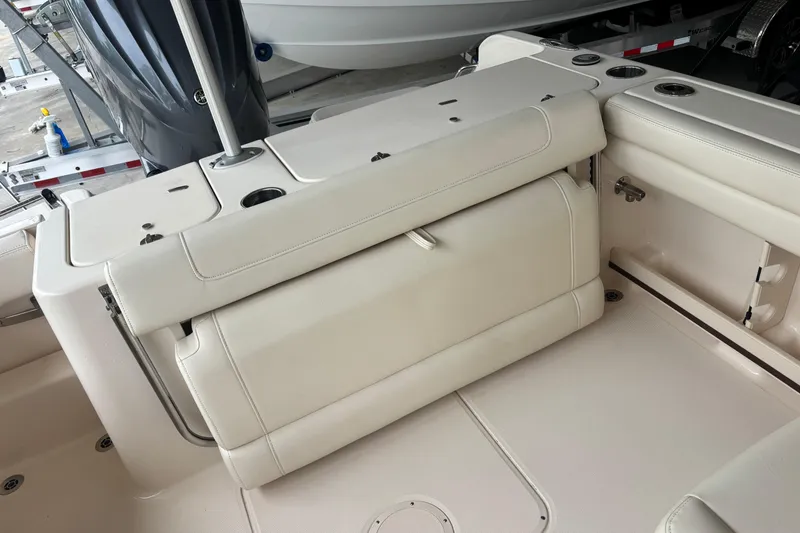 Slide: The Image of 2022 Grady-White Freedom 235 boat interior with foldable seating and cup holders. - 30