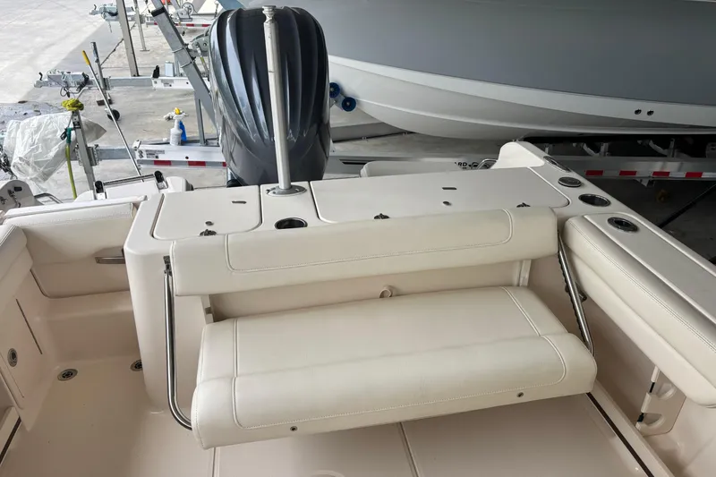Slide: The Image of 2022 Grady-White Freedom 235 boat interior with seating and engine view. - 31