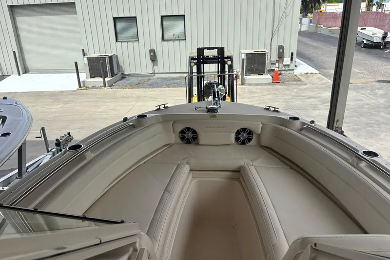 Slide: The Image of 2022 Grady-White Freedom 235 boat interior with beige seating and speakers. - 32