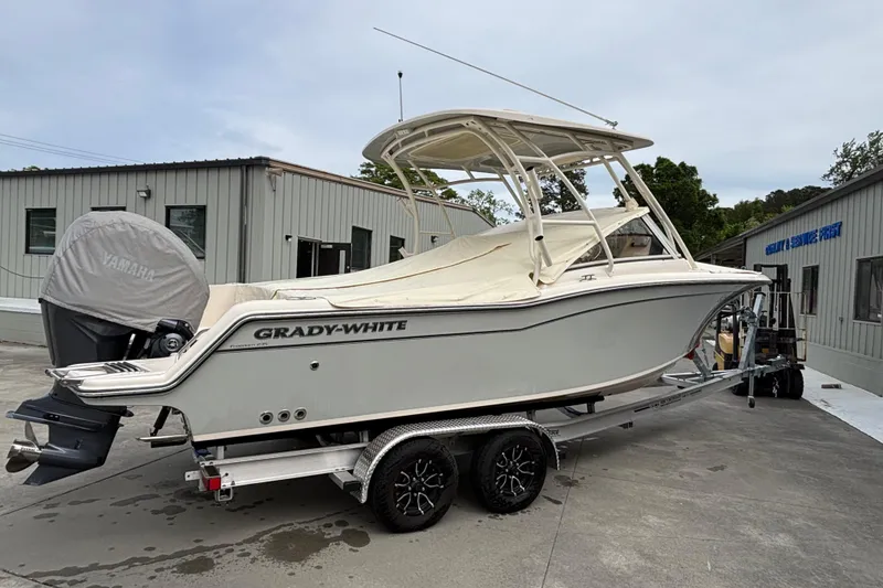 Slide: The Image of 2022 Grady-White Freedom 235 boat on trailer, parked outside service facility. - 4