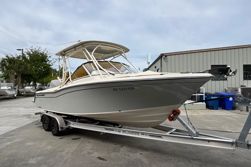 Slide: The Image of 2022 Grady-White Freedom 235 boat on trailer, parked outdoors near a building. - 5
