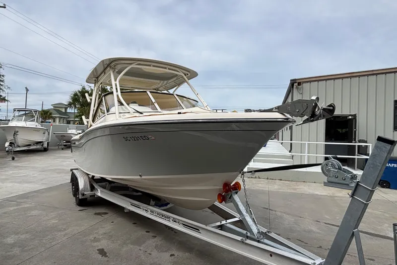 Slide: The Image of 2022 Grady-White Freedom 235 boat on trailer, parked outside a building. - 6
