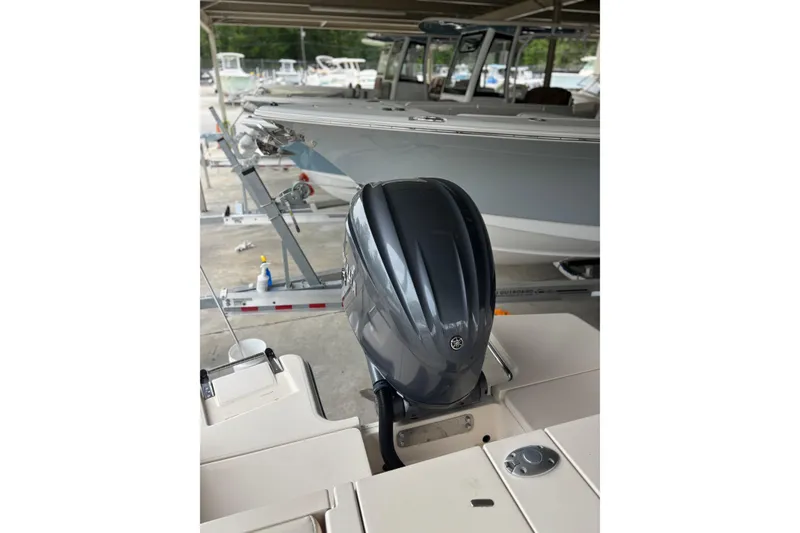 Slide: The Image of 2022 Grady-White Freedom 235 boat with Yamaha outboard motor in a marina setting. - 9