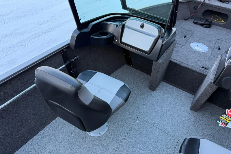 Slide: The Image of 2026 Crestliner 1650 Kodiak boat interior with seating and storage compartments. - 13