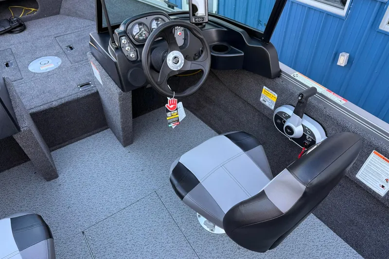 Slide: The Image of Interior of 2026 Crestliner 1650 Kodiak boat with steering wheel and seating. - 14