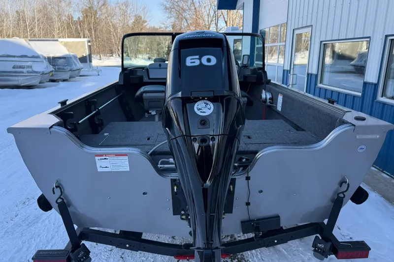 Slide: The Image of 2026 Crestliner 1650 Kodiak boat with Mercury 60 engine, parked outdoors in winter. - 4