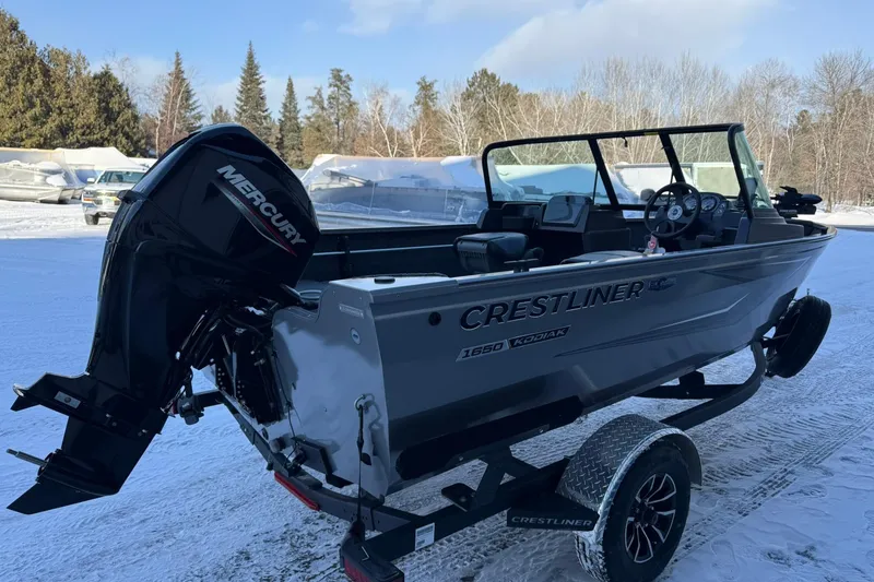 Slide: The Image of 2026 Crestliner 1650 Kodiak boat with Mercury engine on snowy landscape. - 5