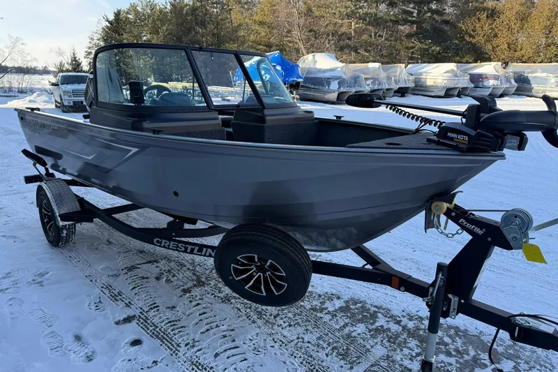 Slide: The Image of 2026 Crestliner 1650 Kodiak boat on trailer, parked on snowy ground. - 6
