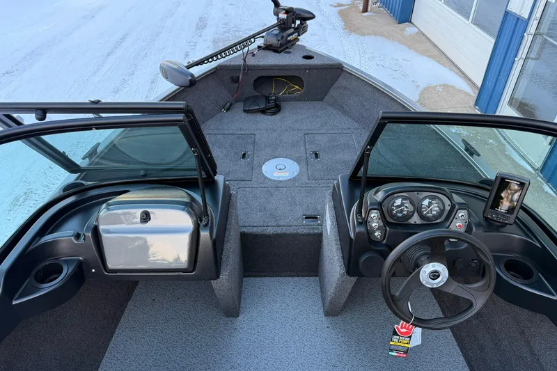 Slide: The Image of 2026 Crestliner 1650 Kodiak boat interior with steering wheel and control panel. - 8