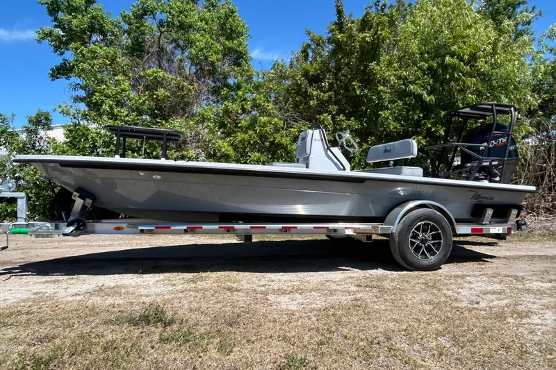The Image of 2026 Maverick 18 HPX-V boat on trailer, parked outdoors with trees in background. - 0