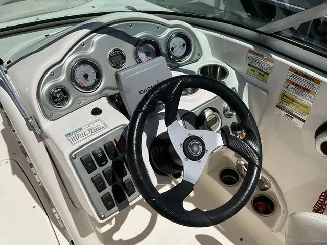 Slide: The Image of Dashboard of a 2008 Hurricane SunDeck 2000 boat with steering wheel and gauges. - 12