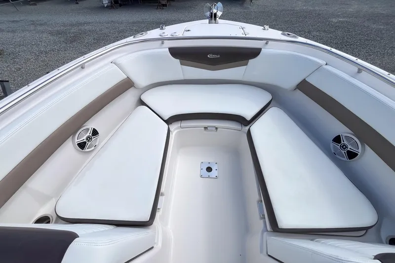 Slide: The Image of 2020 Robalo R247 Dual Console boat interior with cushioned seating and speakers. - 10