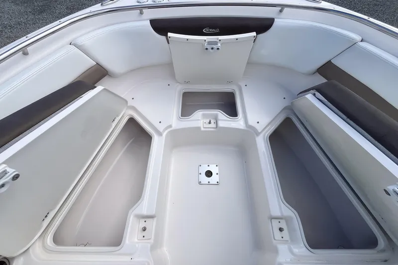 Slide: The Image of 2020 Robalo R247 Dual Console boat interior with spacious seating and storage compartments. - 11