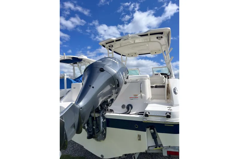 Slide: The Image of 2020 Robalo R247 Dual Console boat with outboard motor under blue sky. - 15