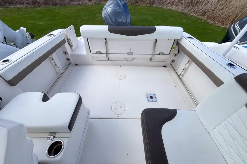 Slide: The Image of 2020 Robalo R247 Dual Console boat interior with spacious seating and storage. - 2