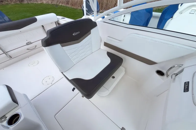 Slide: The Image of 2020 Robalo R247 Dual Console boat interior with cushioned seating and sleek design. - 9