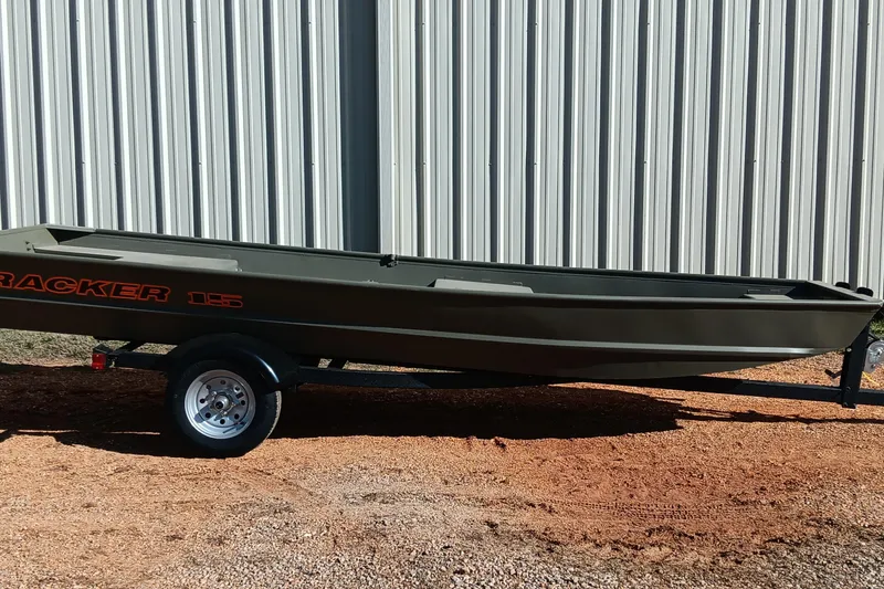 The Image of 2026 Tracker Topper 1542 LW Riveted Jon boat on trailer, parked outdoors. - 0
