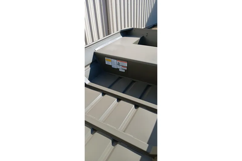 Slide: The Image of 2026 Tracker Topper 1542 LW Riveted Jon boat interior with warning labels. - 10