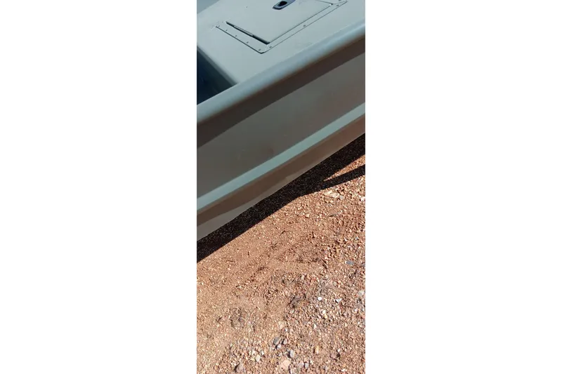 Slide: The Image of 2026 Tracker Topper 1542 LW Riveted Jon boat on gravel surface. - 12