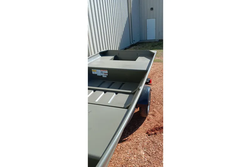 Slide: The Image of 2026 Tracker Topper 1542 LW Riveted Jon boat on trailer, parked outdoors. - 13